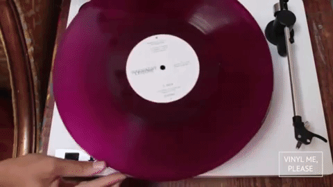 Gif of woman listening to a plum velvet vinyl record